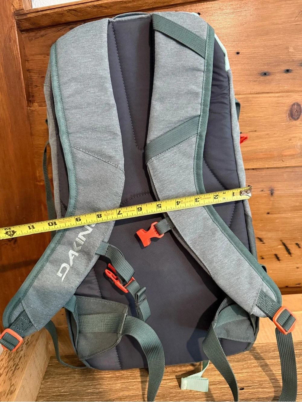 Dakine Mint tinted heli pack 12 backpack with Orange Buckles